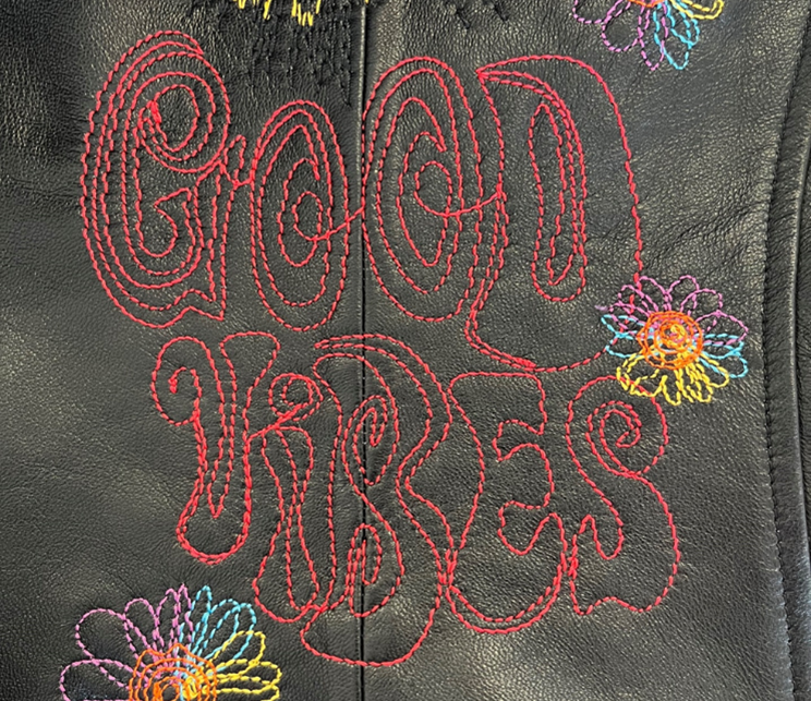 In contrast to the thick threads, Isacord provides a finer and more controlled look for the “Good Vibes” lettering.
